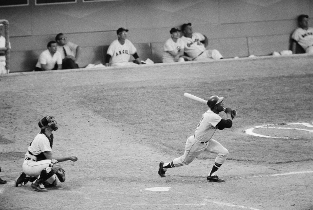 1967 Atlanta Braves players including Hank Aaron and Joe Torre at Atlanta-Fulton County Stadium during a summer baseball game.